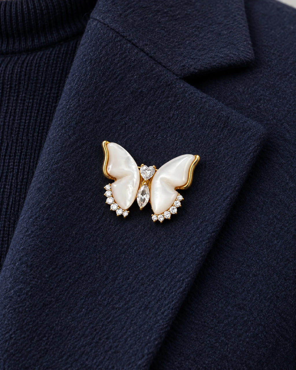 Lento Sculpted Butterfly Magnetic Brooch, Gold & White worn on a navy jacket lapel, close view