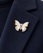 Lento Sculpted Butterfly Magnetic Brooch, Gold & White worn on a navy jacket lapel, close view