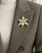 Lilja Stone-Set Lily Brooch — close wearing view on a tailored lapel