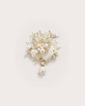Linnea Pearl Shell Flower Brooch on a warm pale studio background with a natural contact shadow