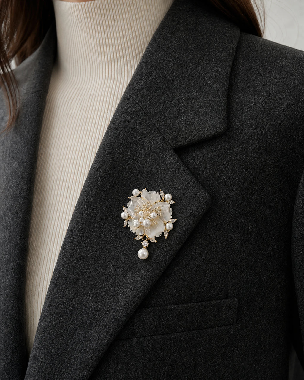 Close view of the 4.5 by 6.0 centimetre Linnea Brooch pinned fully to a folded charcoal blazer lapel