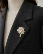 Close view of the 4.5 by 6.0 centimetre Linnea Brooch pinned fully to a folded charcoal blazer lapel
