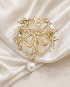 Reverse of Linnea Pearl Shell Flower Brooch showing its gold-tone openwork frame, hinge, pin stem and clasp