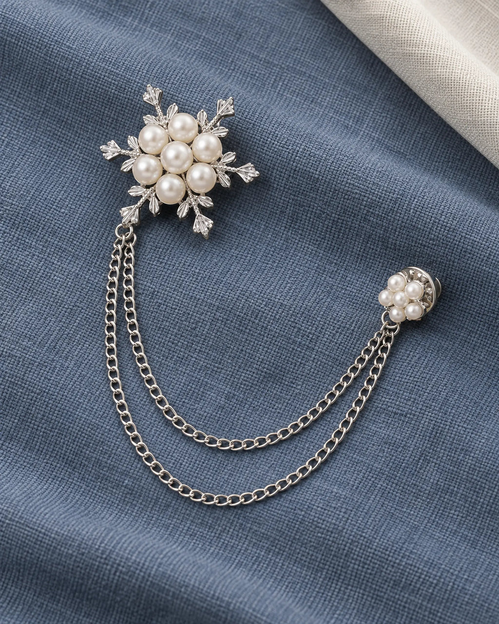 Lume Snowflake Lapel Chain Brooch in silver-tone finish; complete still-life drape