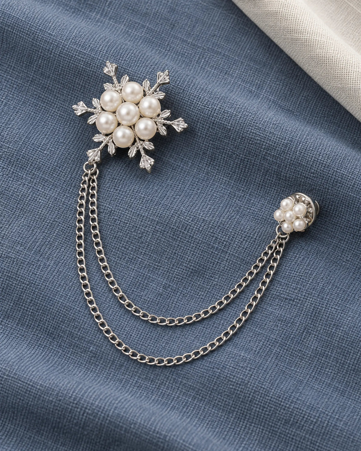 Lume Snowflake Lapel Chain Brooch in silver-tone finish; complete still-life drape