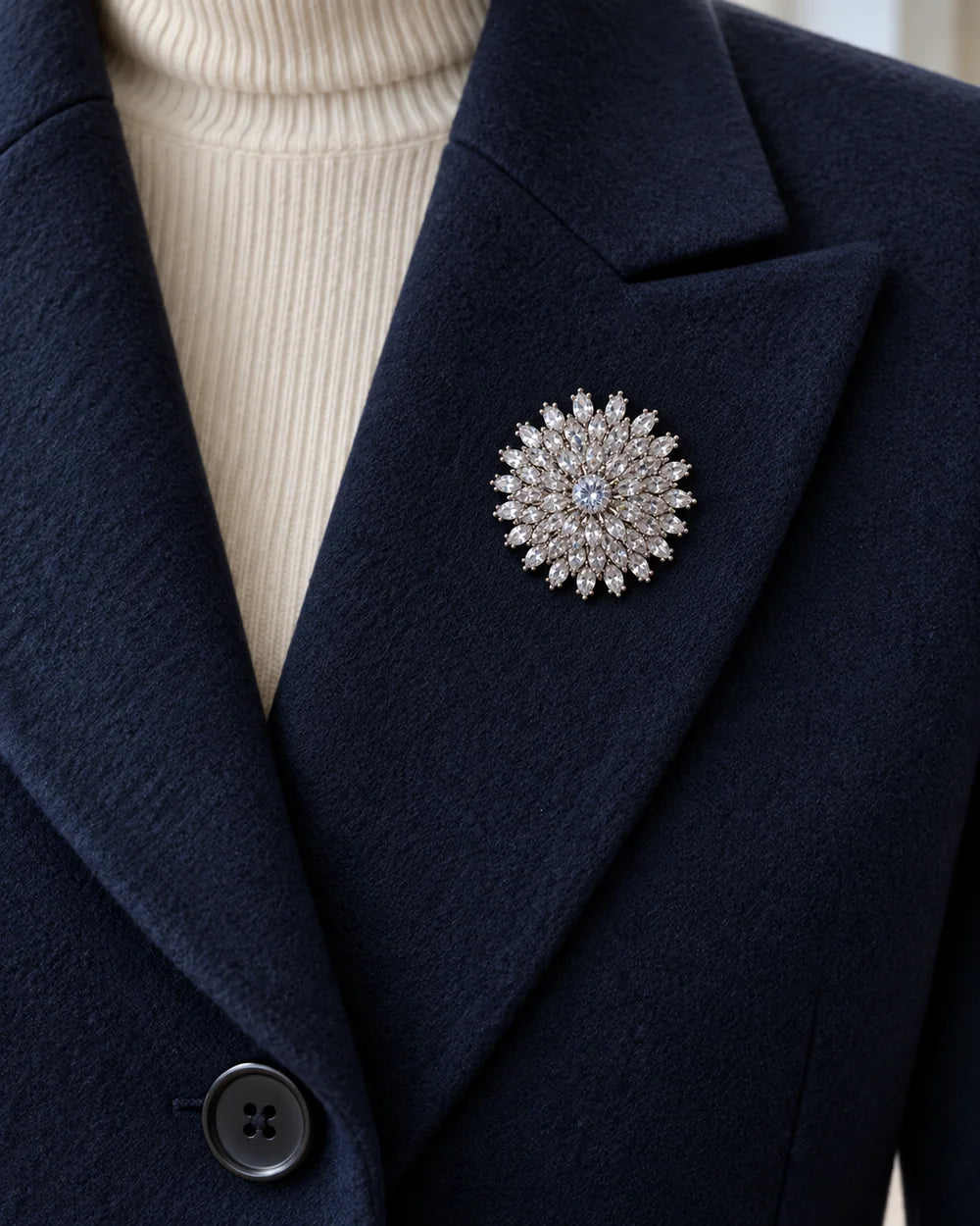 Lumi silver-tone snowflake brooch fully contained on a navy wool lapel