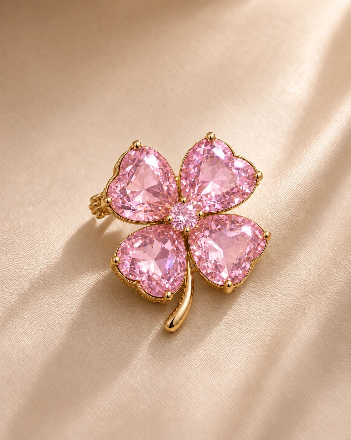 Rose Pink Petite Edition Lykke Clover Brooch with four pink heart-cut stones on ivory fabric