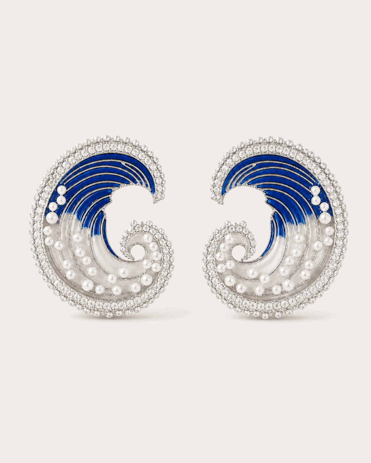 Marea Crystal Wave Stud Earrings in Silver Tone on a soft blush background