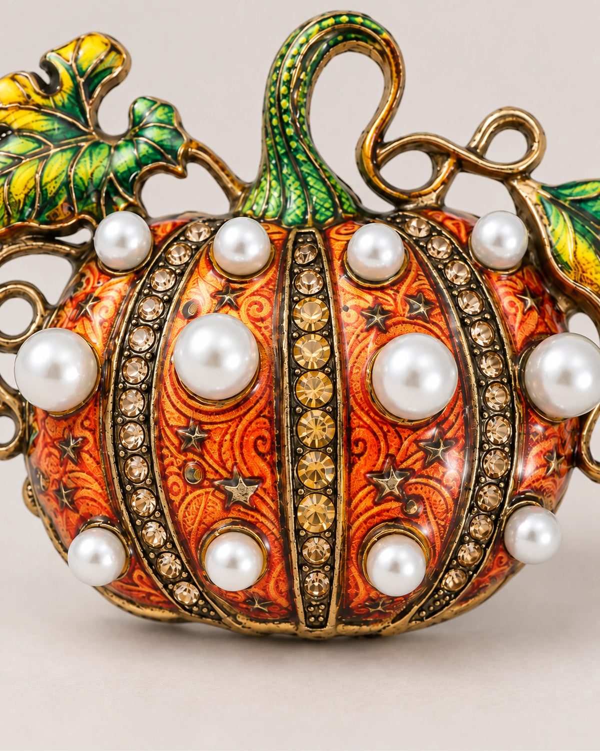 Rounded white pearl-style beads alternate with crystal-set ribs across the Orange pumpkin.