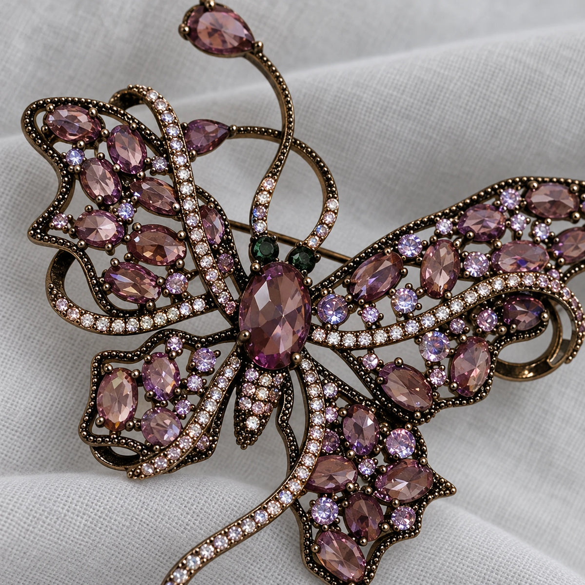 Close detail of Nemi Smoky Purple Butterfly Brooch showing the actual stone settings and layered construction.