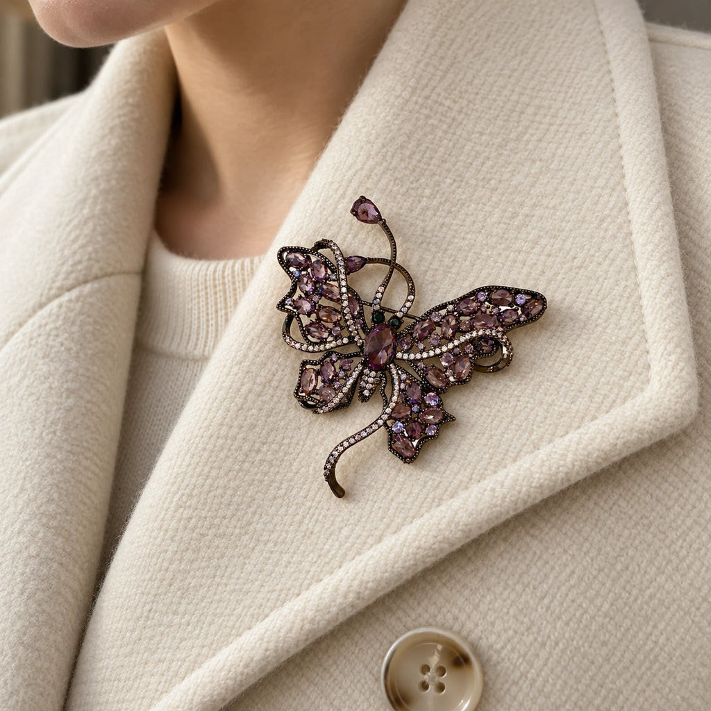 Nemi Smoky Purple Butterfly Brooch pinned completely inside one broad ivory wool lapel.