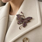 Nemi Smoky Purple Butterfly Brooch pinned completely inside one broad ivory wool lapel.