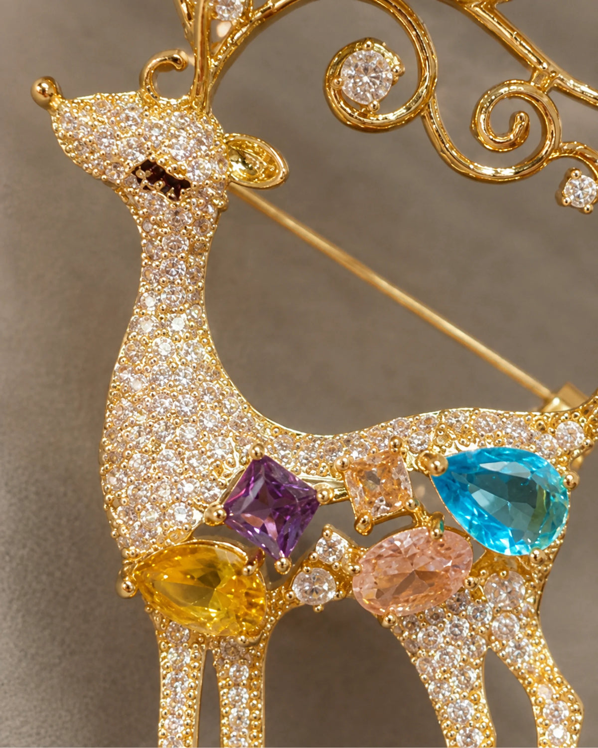 Detail of Niva's stone-set silhouette, colored accents and diagonal pin.