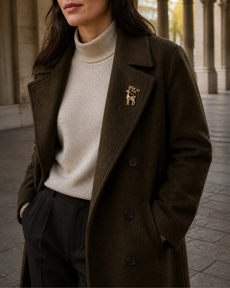 Wider wearing view of Niva on an olive coat and ivory knit.