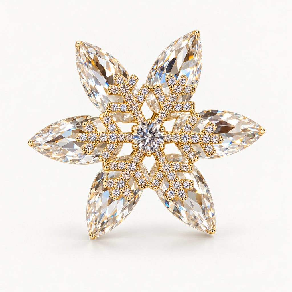 Nive K9 Crystal Rotating Snowflake Brooch, complete Gold finish on a warm plain background.