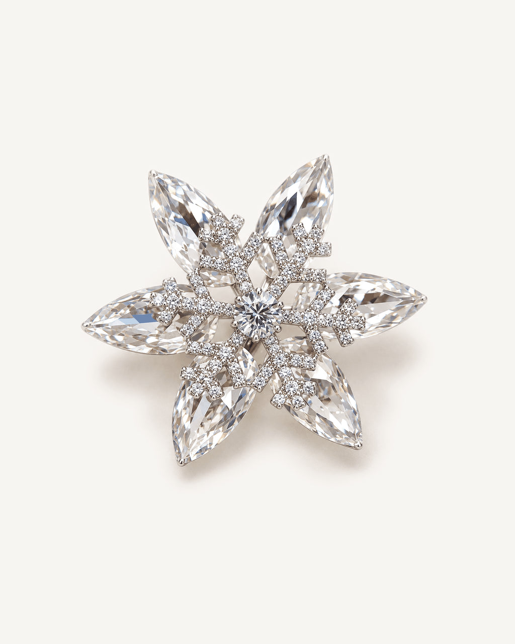Nive K9 Crystal Rotating Snowflake Brooch shown complete on a warm plain background.
