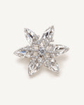 Nive K9 Crystal Rotating Snowflake Brooch shown complete on a warm plain background.