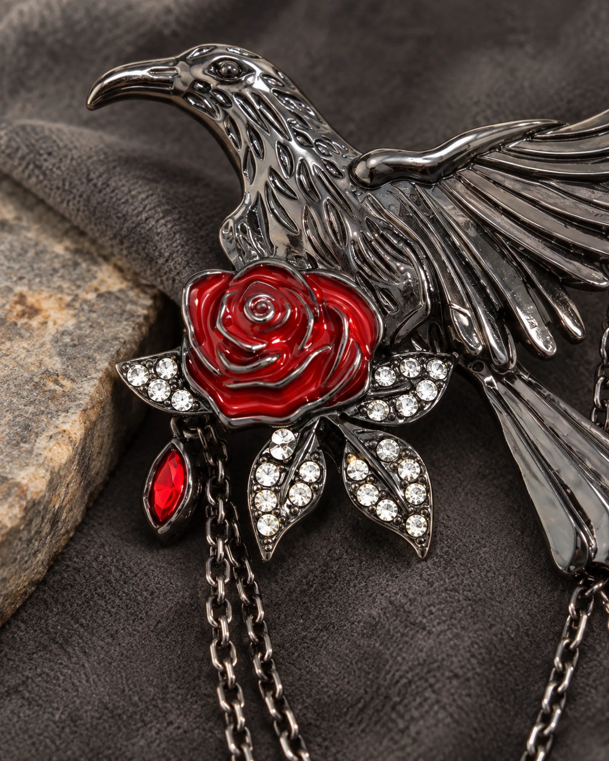 Detail of Noctra red rose, four clear-stone leaves and gunmetal-tone feathers