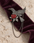 Noctra brooch and two gunmetal chains on plum velvet and pale limestone