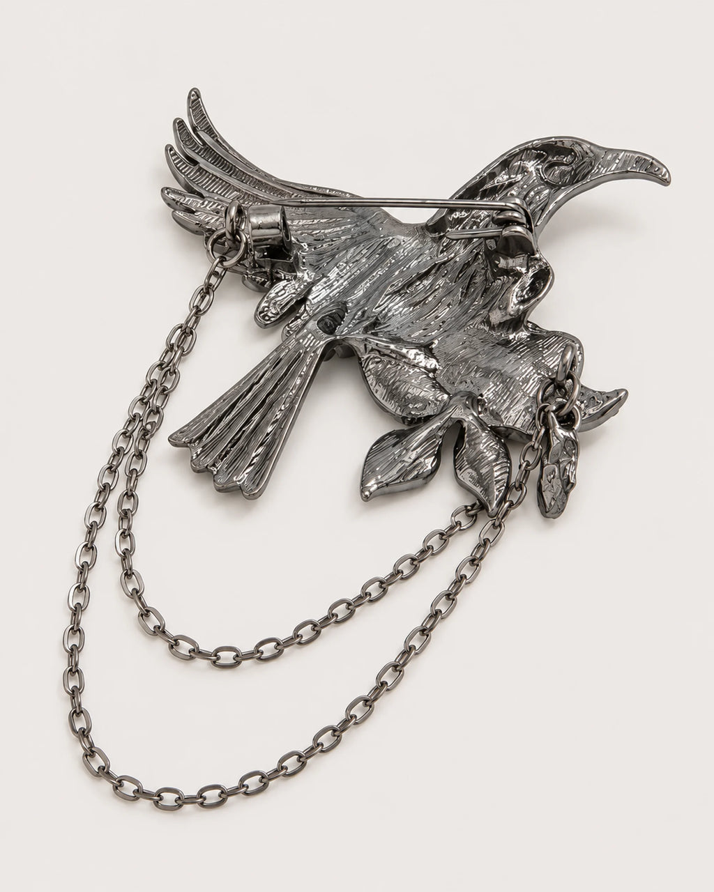 Back of Noctra bird and rose brooch showing one hinged pin and two chains