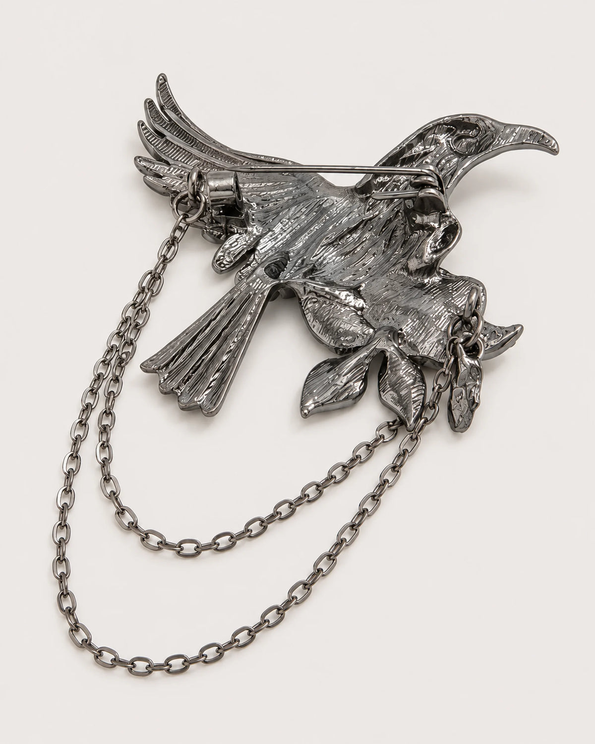 Back of Noctra bird and rose brooch showing one hinged pin and two chains