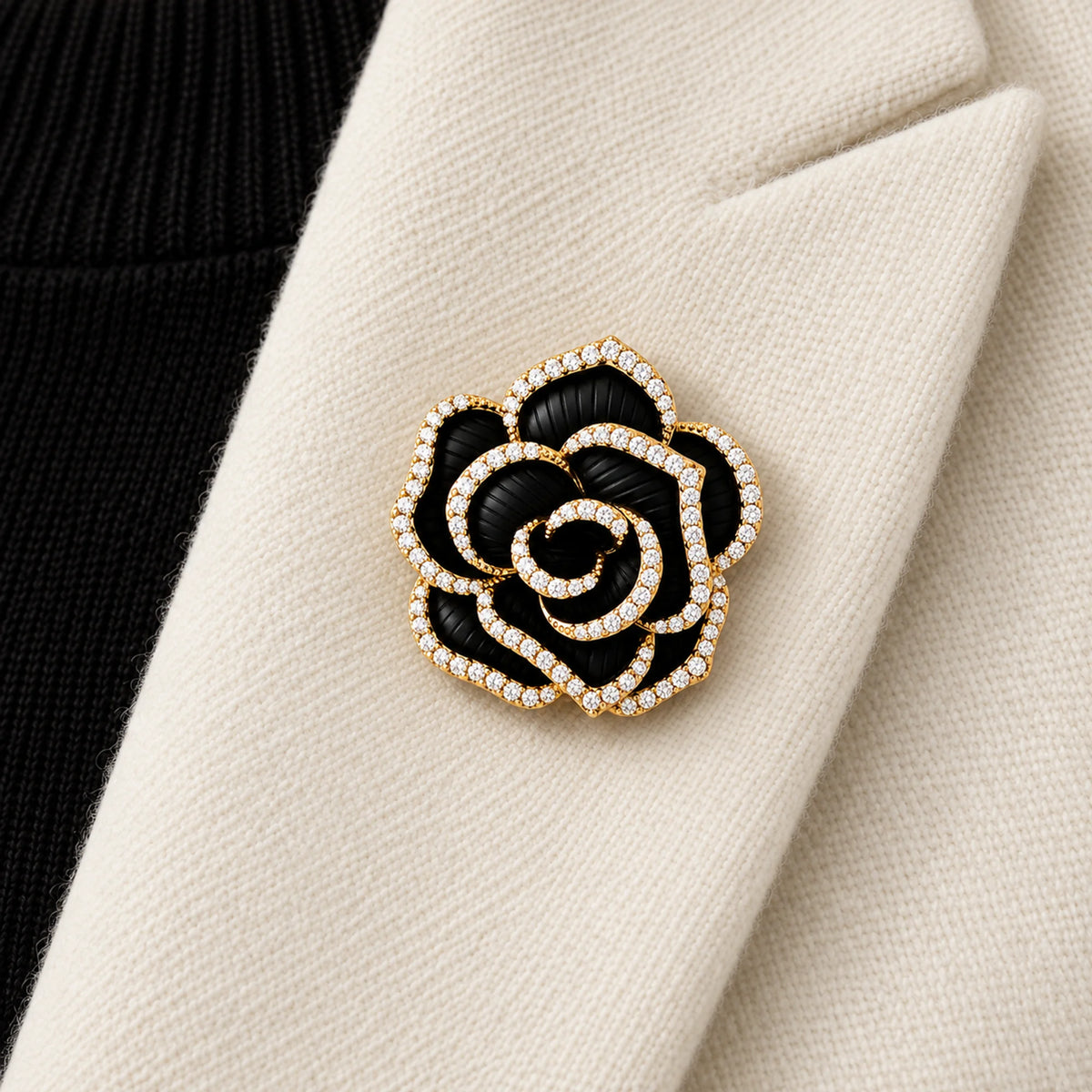 Noir black camellia brooch pinned inside an ivory folded blazer lapel in a local close view