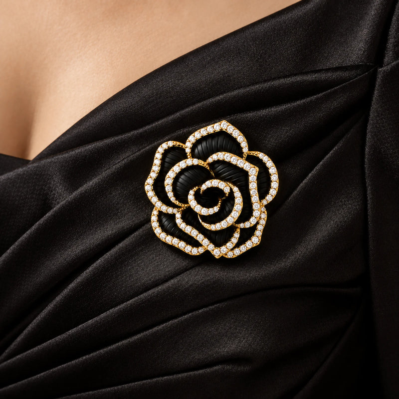 Noir black camellia brooch pinned to the draped fabric of a black evening dress in a local neckline close-up