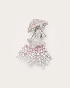 Noora Crystal Parasol Lady Brooch in silver tone with pink and clear crystals on a warm pale background