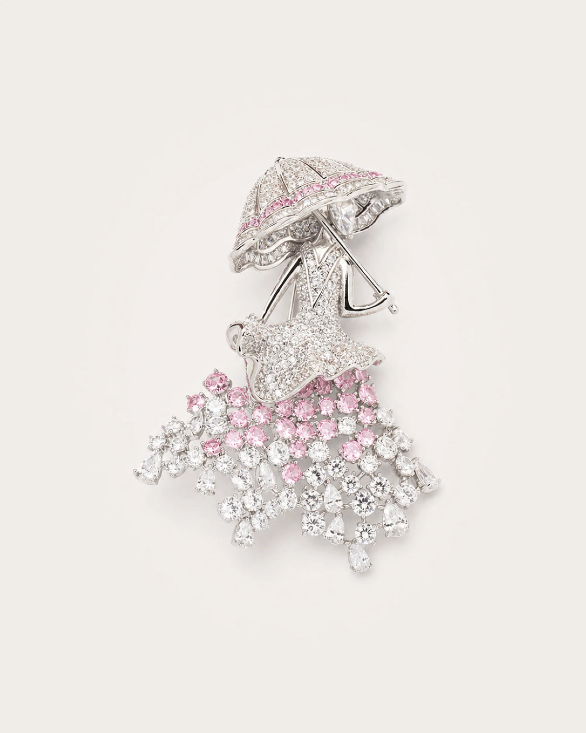 Noora Crystal Parasol Lady Brooch in silver tone with pink and clear crystals on a warm pale background
