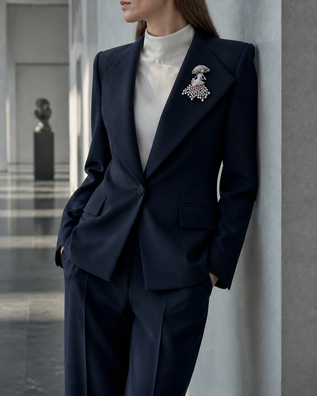 Wide view of Noora at true scale on a navy suit lapel