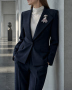 Wide view of Noora at true scale on a navy suit lapel