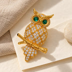 Complete Oiva Green-Eyed Zircon Owl Brooch in an original still life on ivory paper.