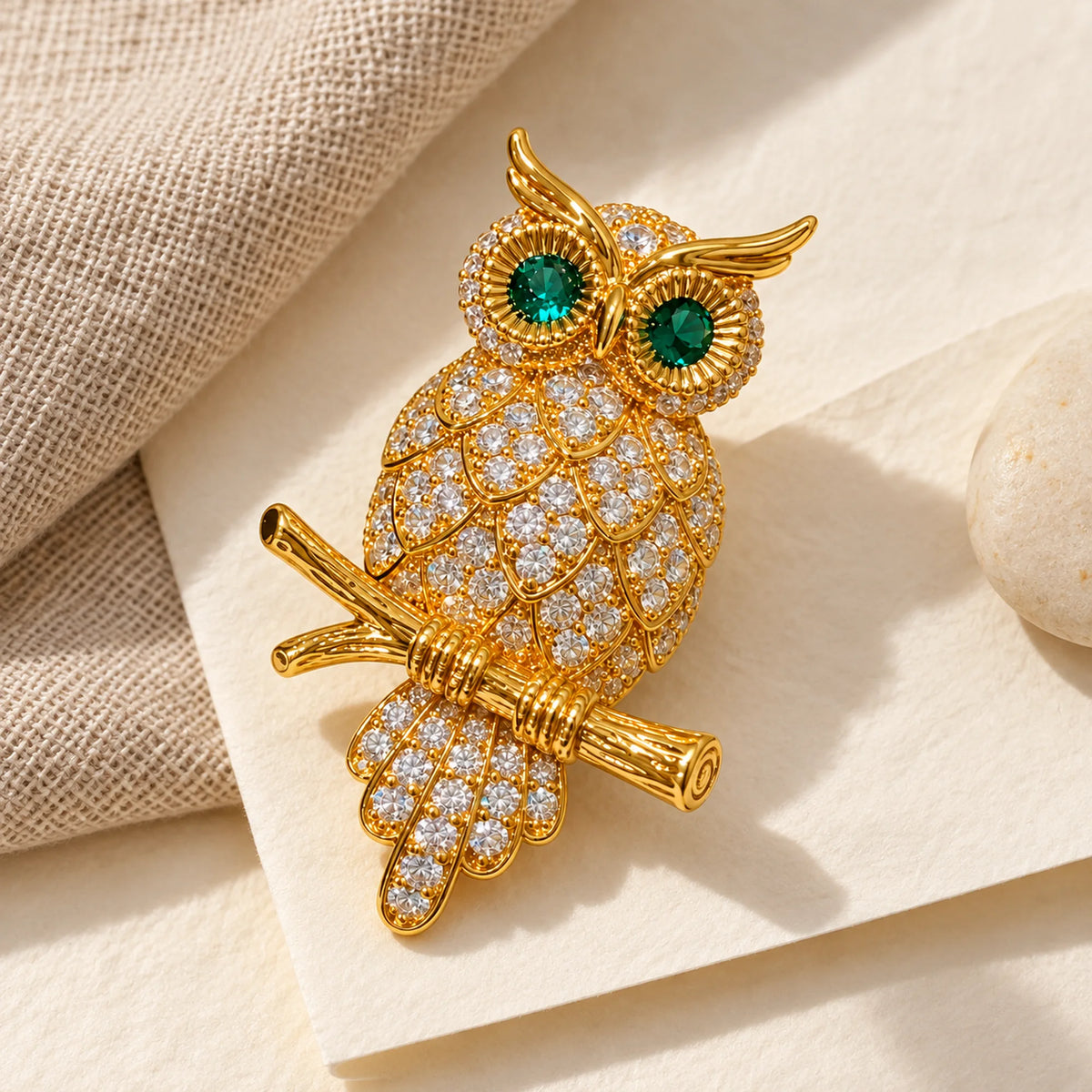 Complete Oiva Green-Eyed Zircon Owl Brooch in an original still life on ivory paper.