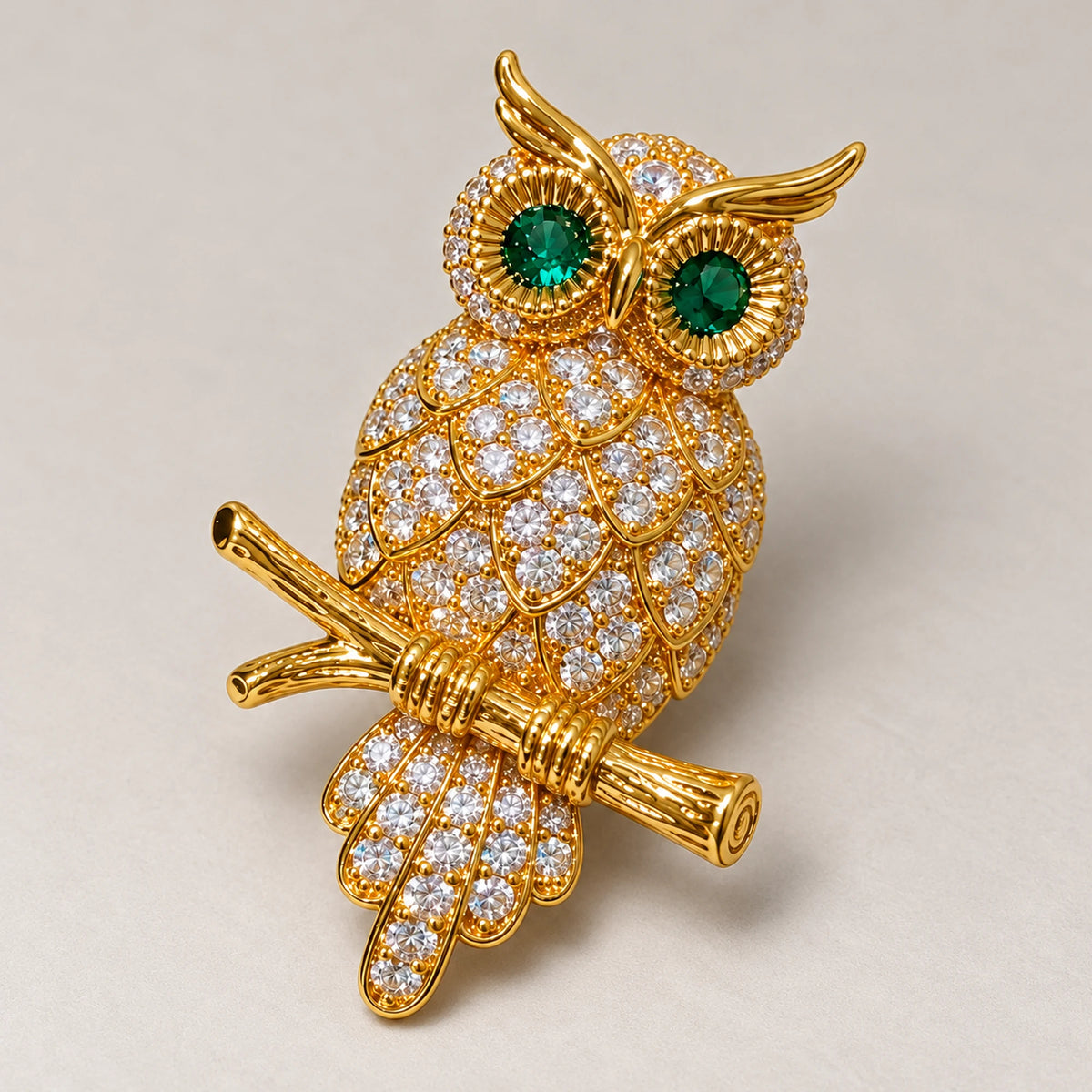 Oiva Green-Eyed Zircon Owl Brooch in an oblique front view showing raised settings and dimensional construction.