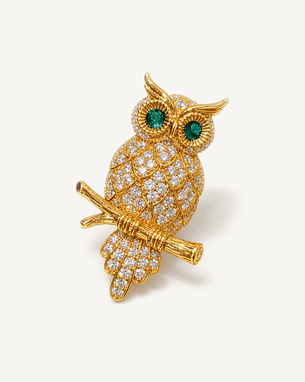 Oiva Green-Eyed Zircon Owl Brooch shown complete on a warm plain background.