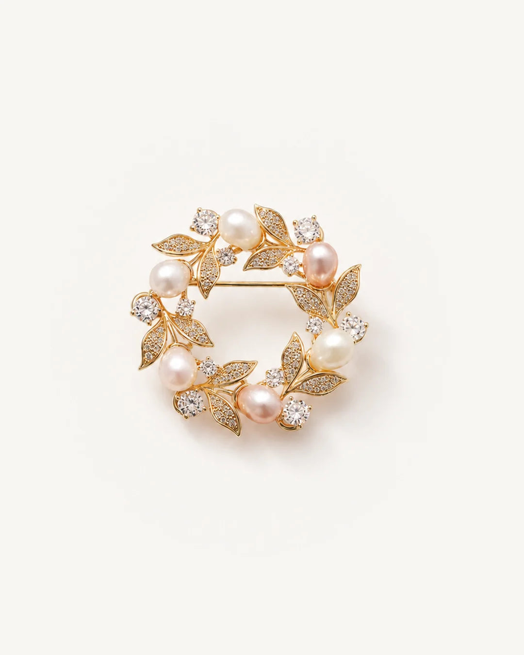 Olea Freshwater Pearl Wreath Brooch on a warm pale studio background with a natural contact shadow