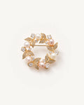 Olea Freshwater Pearl Wreath Brooch on a warm pale studio background with a natural contact shadow