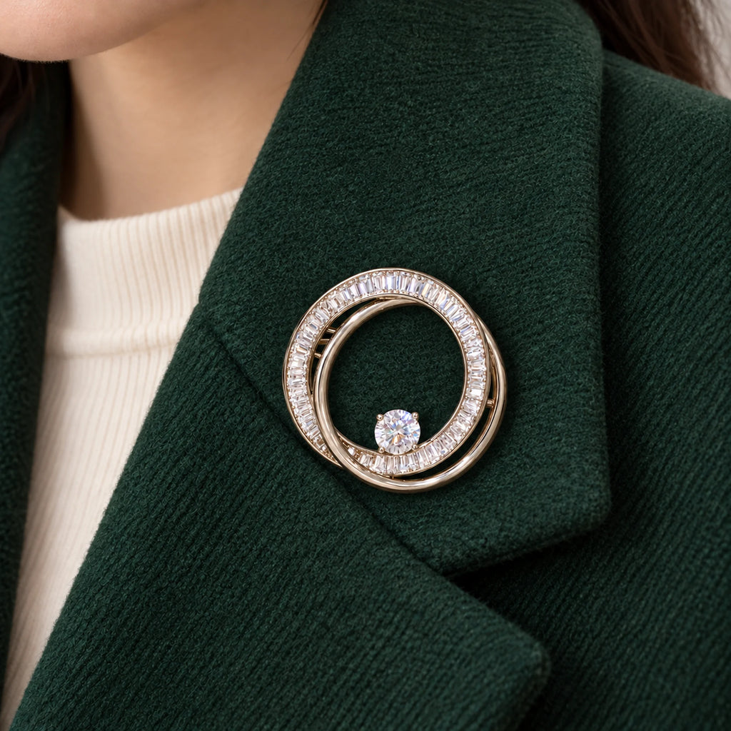 The small double loop rests within one broad forest-green wool lapel.