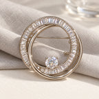 Complete Oona Baguette Zircon Double-Loop Brooch in an original still life on paper and linen.
