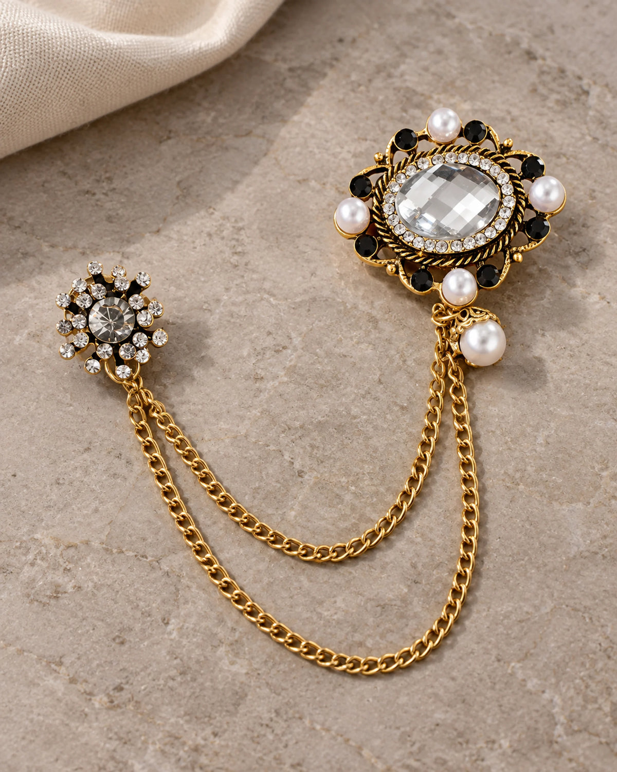 Ova Oval Beaded Lapel Chain Brooch in gold-tone finish; complete still-life drape