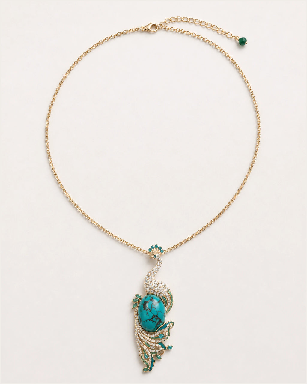 Pava Turquoise-Tone Peacock Pendant Necklace on an exact #F0EBE9 studio background with natural contact shadow.