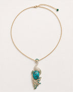 Pava Turquoise-Tone Peacock Pendant Necklace on an exact #F0EBE9 studio background with natural contact shadow.