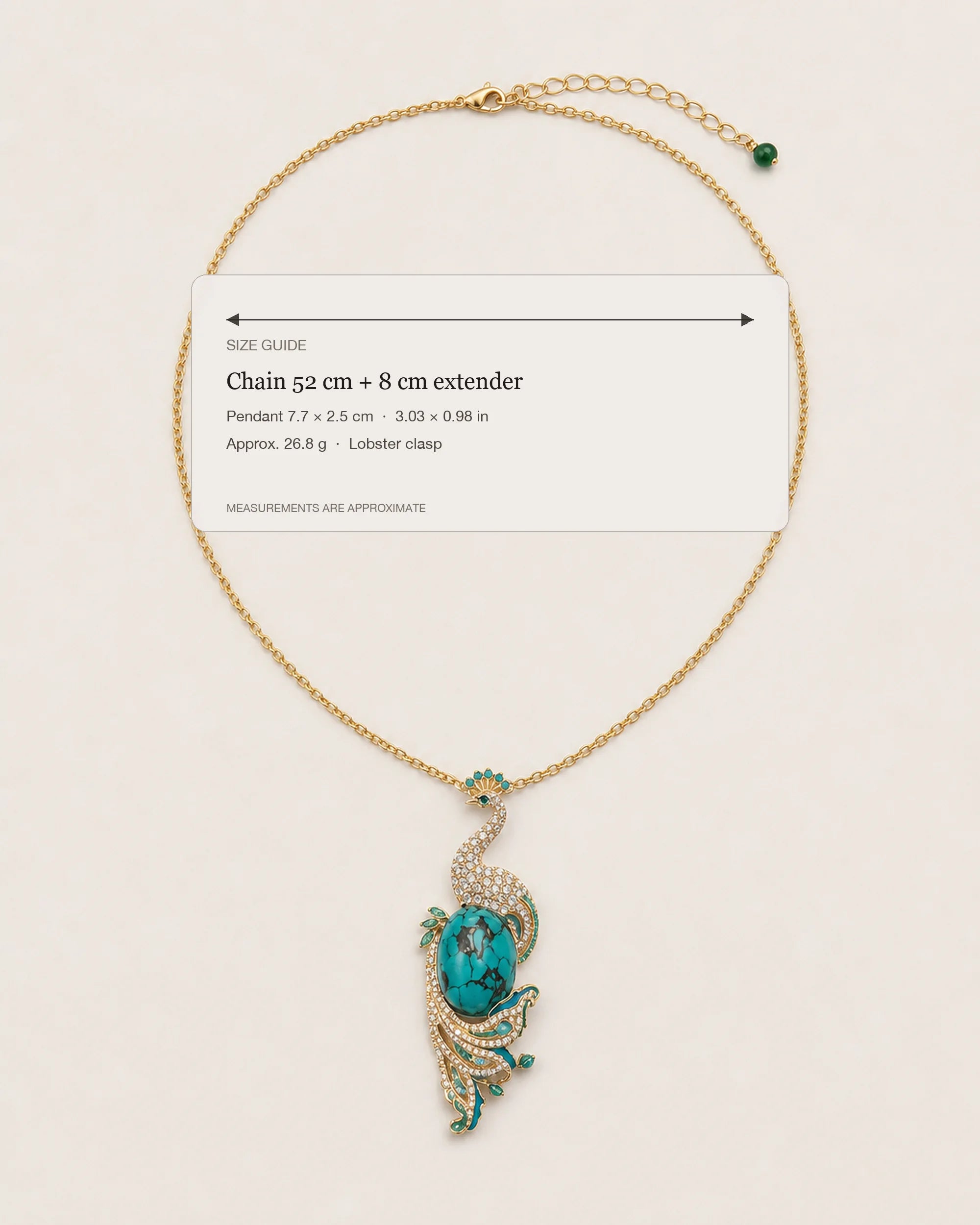 Pava Turquoise-Tone Peacock Pendant Necklace size guide showing a 52 cm chain, 8 cm extender, 7.7 by 2.5 cm pendant and 26.8 g weight.