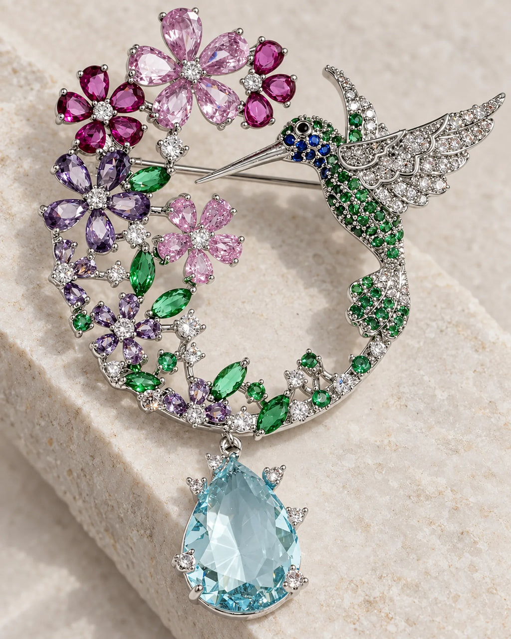 Close view of Pihla’s silver-tone wing, colored flowers and aqua drop
