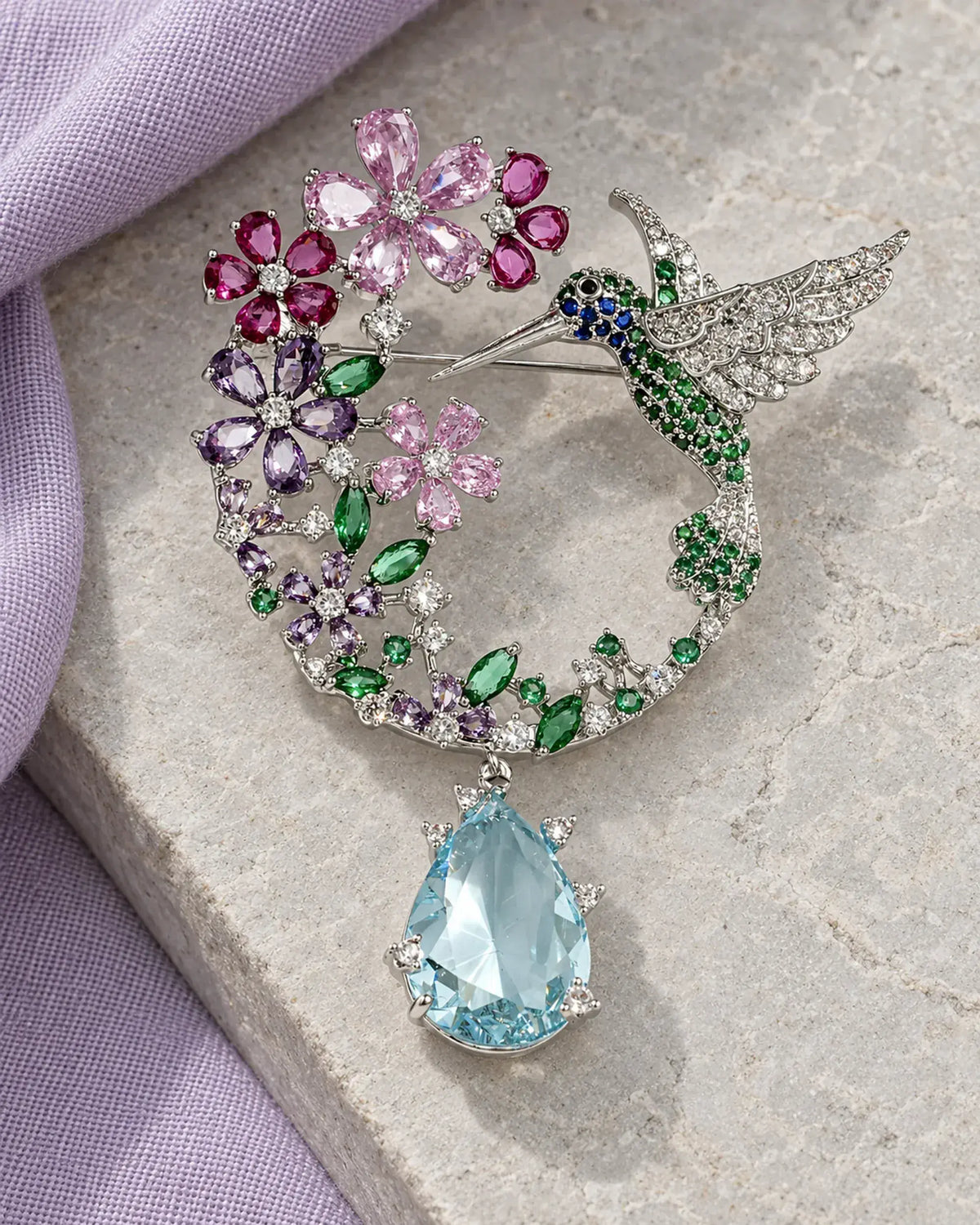 Pihla floral wreath brooch on limestone beside lavender linen