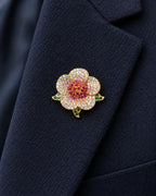 Pihla Pavé Flower Magnetic Brooch, Gold & Red worn on a navy jacket lapel, close view