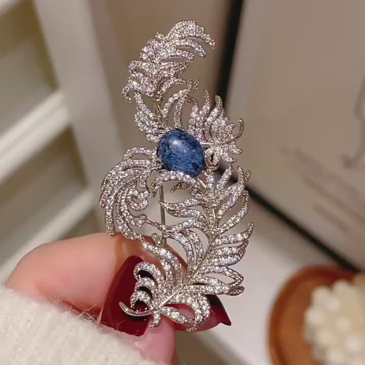 Tuire Blue-Centre Zircon Feather Brooch in a silent product film. 