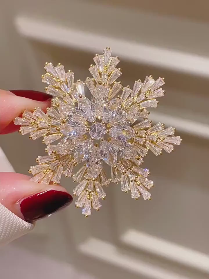 Halla Eight-Point Crystal Snowflake Brooch in Gold shown from multiple angles in motion