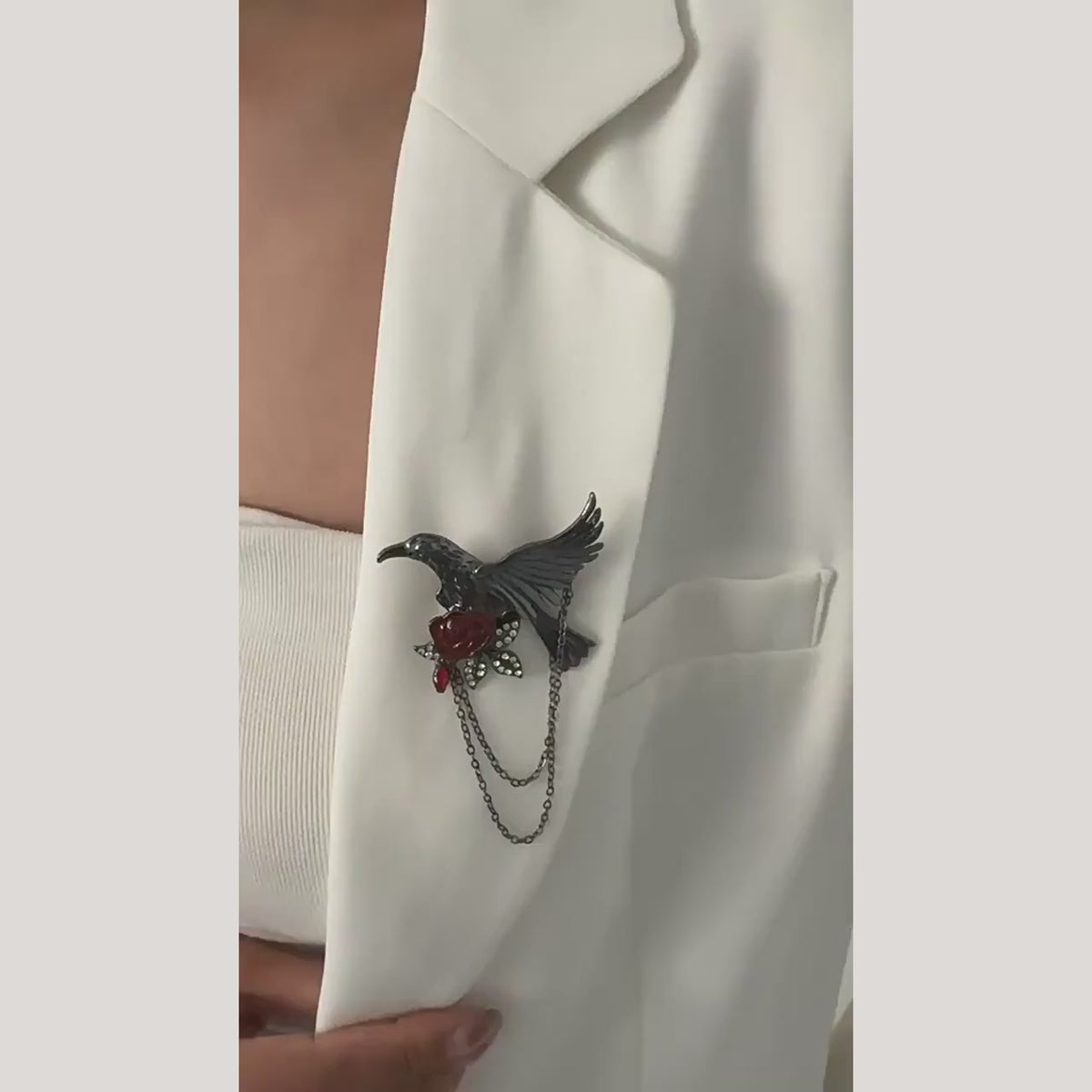 Noctra bird and rose chain brooch turning to show the front, back and two chains