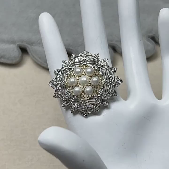Silent 18.5-second film of Solveig freshwater pearl rosette brooch, showing its front and pin back.